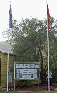 Pretty Beach School captains, Siann McPhee and Cosmo Porter-Witt raising the Australian and Aboriginal flags.